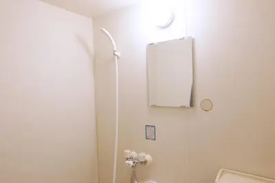 a bathroom with a toilet and a mirror on the wall at Heisei Mansion - Vacation STAY 17520 in Tokyo