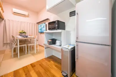 a small kitchen with a refrigerator and a table at Kita Akabane-Diamond Yu - Vacation STAY 84219v in Tokyo