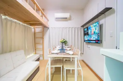a dining room with a table and chairs and a tv at Kita Akabane-Diamond Yu - Vacation STAY 84219v in Tokyo