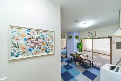 a room with a welcome home sign on the wall at Belmont 201 3min to Station Easy Access Ueno Asakusa Skytree Sleeps 5 in Tokyo