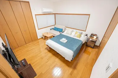 a small bedroom with a bed and a table at Tomo house in Tokyo