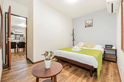 a small bedroom with a bed and a table at Tomo house in Tokyo