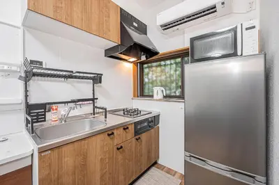 a kitchen with a sink and a refrigerator at Tomo house in Tokyo