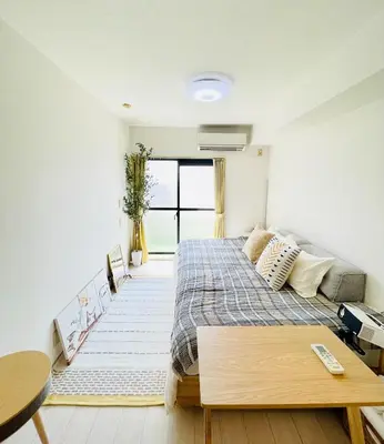 a bedroom with a bed and a table at Alo BnB 14 - Cats and Coffee - Near Shibuya ! Self check-in in Tokyo