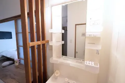 a bathroom with a mirror and a sink at Yoyogi Flats - Vacation STAY 17486 in Tokyo