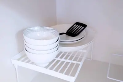 a shelf with a stack of plates and a bowl at Yoyogi Flats - Vacation STAY 17486 in Tokyo