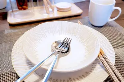 a plate with a fork and a cup on a table at Yoyogi Flats - Vacation STAY 17486 in Tokyo