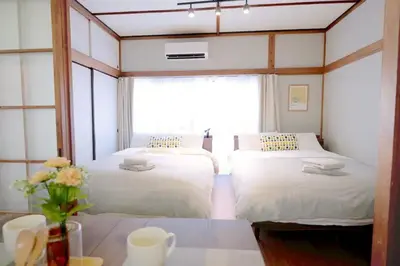 two beds in a room with a window at Yoyogi Flats - Vacation STAY 17487 in Tokyo