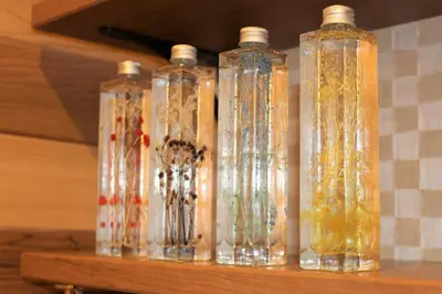 a group of four glass bottles sitting on a shelf at Rakuna Inn \u6cb3 Oshiage in Tokyo
