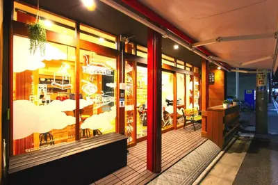 a store front of a restaurant with tables and chairs at Rakuna Inn \u6cb3 Oshiage in Tokyo