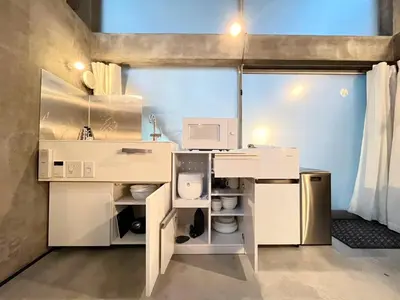 a kitchen with white cabinets and a microwave at \u590f\u76ee\u5742\u306e\u9593Room2 in Tokyo