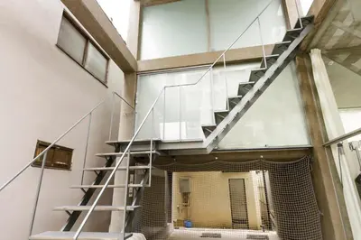 a staircase in a building with glass walls at \u590f\u76ee\u5742\u306e\u9593Room2 in Tokyo