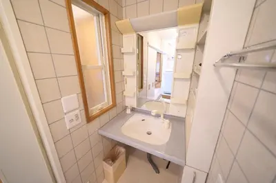 a bathroom with a sink and a mirror at FINOA Penthouse Suite Ikebukuro Sunshine in Tokyo