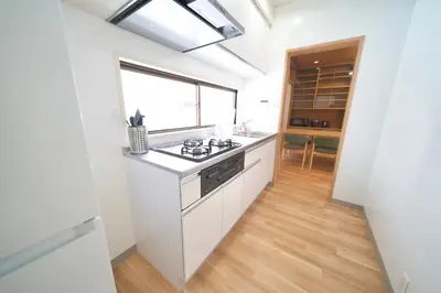 a kitchen with white counters and a stove top oven at FINOA Penthouse Suite Ikebukuro Sunshine in Tokyo