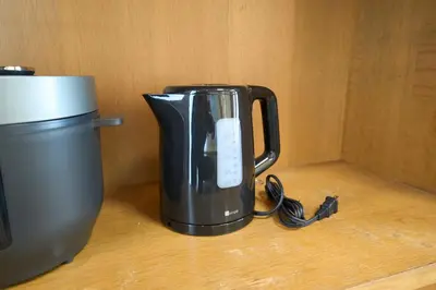 a black coffee pot sitting next to a coffee maker at FINOA Penthouse Suite Ikebukuro Sunshine in Tokyo