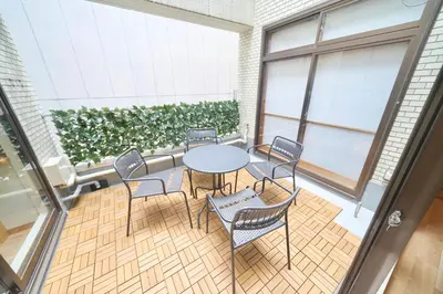 a room with a table and chairs and a plant at FINOA Penthouse Suite Ikebukuro Sunshine in Tokyo