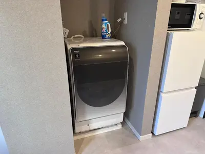 a washer and dryer with a bottle on top of it at COTO Premium Shibuya B in Tokyo