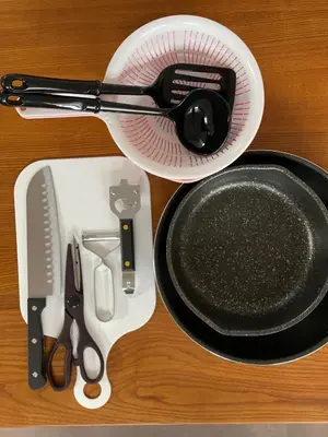 a table with a whisk and a strainer and a skillet at COTO Premium Shibuya B in Tokyo