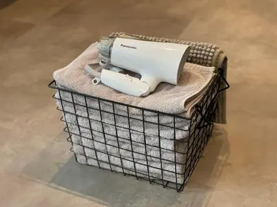 a hair dryer sitting on top of a basket at COTO Premium Shibuya B in Tokyo
