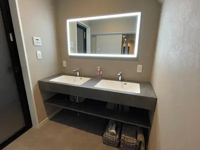 a bathroom with two sinks and a mirror at COTO Premium Shibuya B in Tokyo