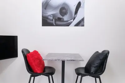 a table and two chairs with a car on the wall at Seacrest Nakanobu by Tranova in Tokyo