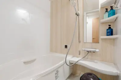 a bathroom with a shower and a white tub at \u5343\u4f4f\u5bff\u753a1f in Tokyo