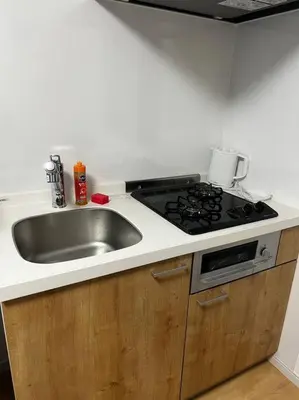 a kitchen with a sink and a stove at \u5343\u4f4f\u5bff\u753a1f in Tokyo