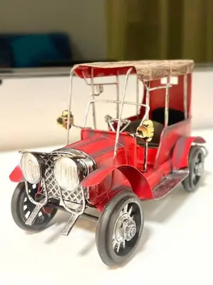 a toy red car is sitting on a table at \u5343\u4f4f\u5bff\u753a2f 3f in Tokyo