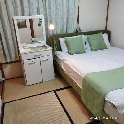 a small bedroom with a bed and a mirror at kyoka house\u6c60\u888b\u81f3\u8fd1 in Tokyo