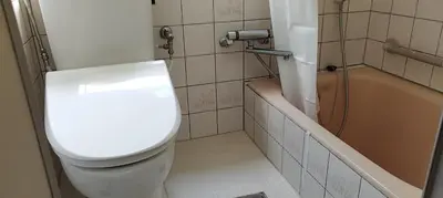 a bathroom with a toilet and a bath tub at kyoka house\u6c60\u888b\u81f3\u8fd1 in Tokyo