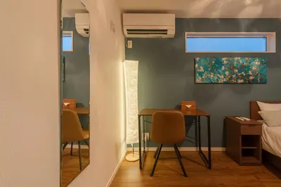 a room with a table and chairs and a bed at \u7d50\u5eb5\u6708\u82b1 in Tokyo