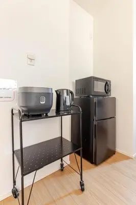 a kitchen with a grill and a refrigerator at \u516b\u5e836\u4e01\u76ee in Tokyo