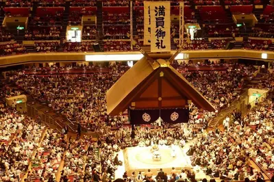 a large crowd of people in a large auditorium at \u516b\u5e836\u4e01\u76ee in Tokyo