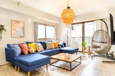 a living room with a blue couch and a table at HARMONIa\u6771\u4eac\u5800\u5207202 in Tokyo