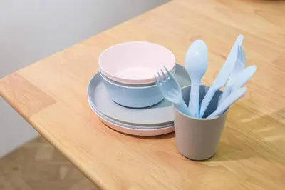 a table with a cup with utensils on it at HARMONIa\u6771\u4eac\u5800\u5207202 in Tokyo