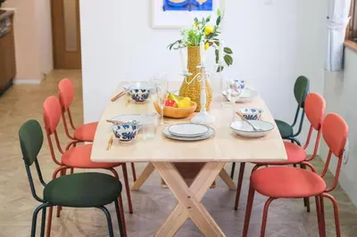 a wooden table with chairs and a bowl of fruit on it at HARMONIa\u6771\u4eac\u5800\u5207202 in Tokyo