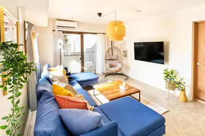 a living room with blue couches and a tv at HARMONIa\u6771\u4eac\u5800\u5207202 in Tokyo