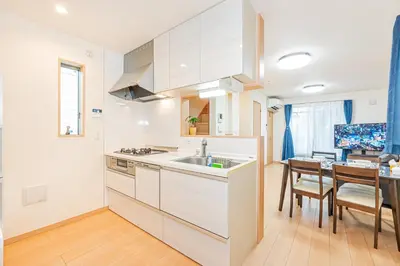 a kitchen with white cabinets and a dining room at Otsuka house with 3BR near the Yamanote line in Tokyo