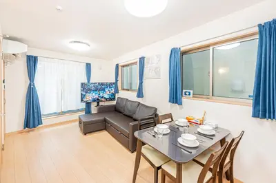 a living room with a couch and a table at Otsuka house with 3BR near the Yamanote line in Tokyo