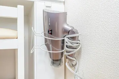 a curling iron is hanging in a closet at Otsuka house with 3BR near the Yamanote line in Tokyo
