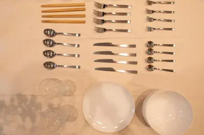 a bunch of tongs and wine glasses on a table at Six7 APT\u4e09\u30ce\u8f2a in Tokyo