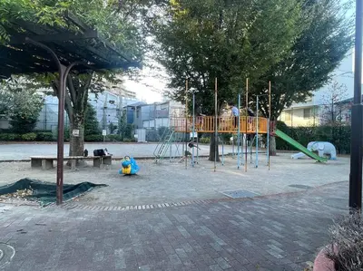 a playground in a park with people on it at Nishisugamo Full Renovated House Next to a Cherry Blossom Park in Tokyo