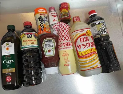 a group of different types of condiments on a shelf at Nishisugamo Full Renovated House Next to a Cherry Blossom Park in Tokyo