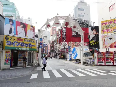 a person crossing a street in a busy city at Mizuken Home in Tokyo