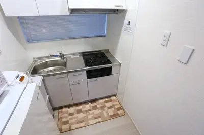 a small kitchen with a sink and a stove at Mizuken Home in Tokyo