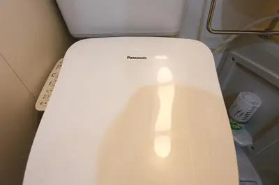 a white toilet with a light on the lid at Mizuken Home in Tokyo