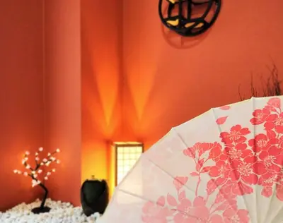 a room with an orange wall with a white umbrella at \u7acb\u77f35\u4e01\u76eem202 in Tokyo