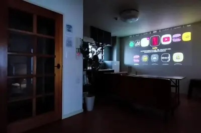 a room with a sign with iphones on the wall at \u7acb\u77f35\u4e01\u76eem202 in Tokyo