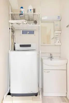a white refrigerator with a sink in a room at \u65b0\u4e951\u4e01\u76ee in Tokyo