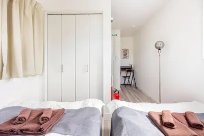a bedroom with two beds with towels on them at \u65b0\u4e951\u4e01\u76ee in Tokyo